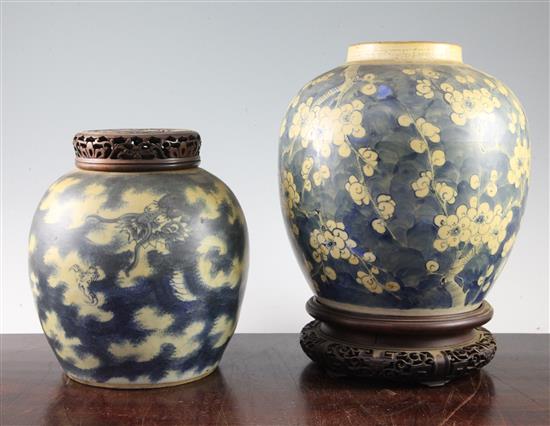 Two Chinese blue and white ovoid jars, 19th century, largest 23cm, carved wood stands and cover